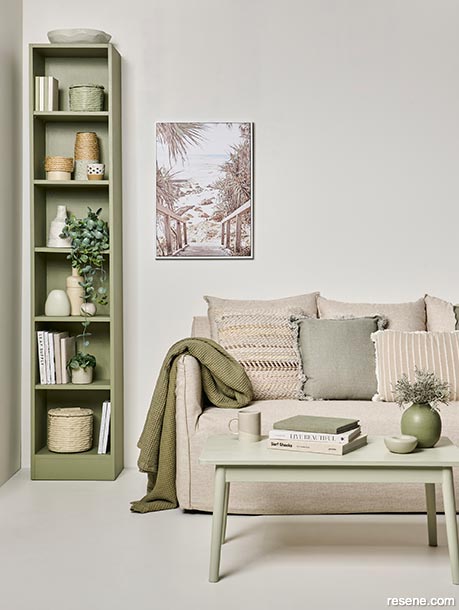 A neutral lounge with green hued accessories