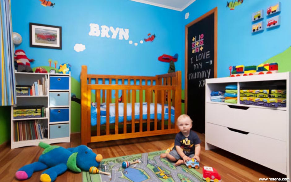 A blue kid's room with a train, plane, and car theme