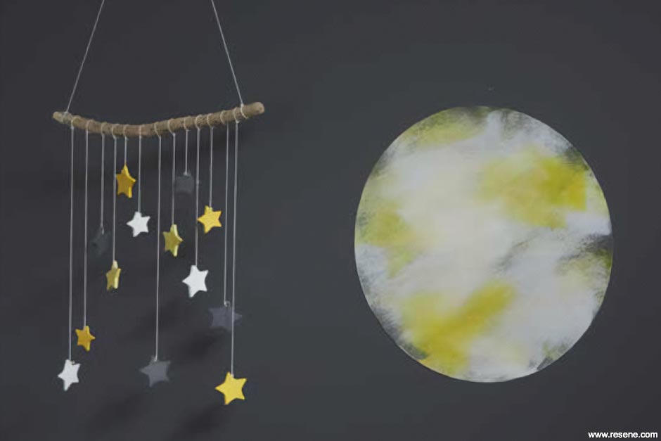 Nursery with star mobile and moon mural