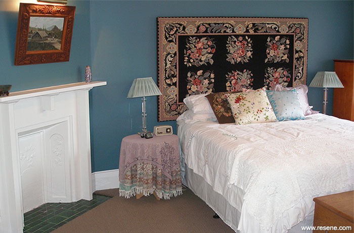 A guest bedroom painted with Resene Tax Break which is a vibrant prussian blue