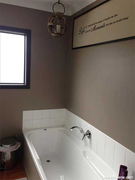 Resene Gargoyle makes the white vanity, toilet, bath and shower 'pop'