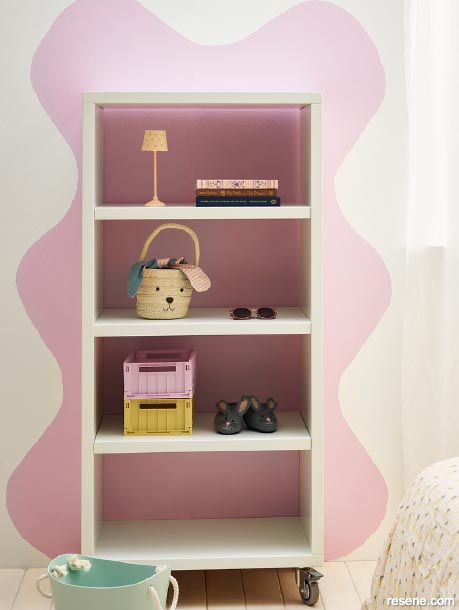 A shelf and pink wave mural