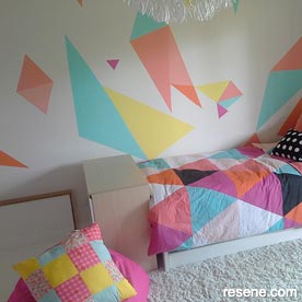 Painted triangles on bedroom wall