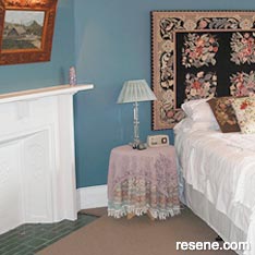 A guest bedroom painted with a vibrant Prussian blue