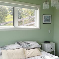 Light green and white guest room