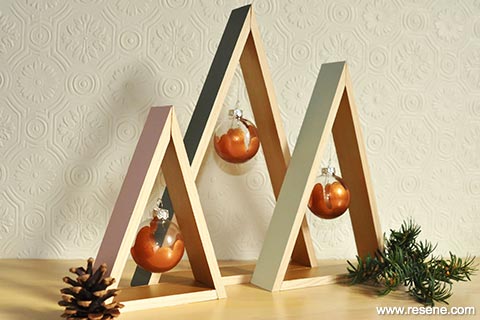 Triangle christmas trees with golden baubles