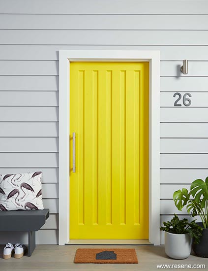 Yellow front door and painted doormat