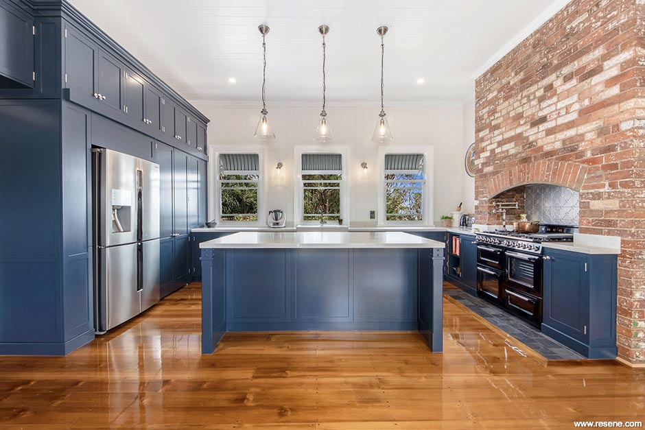 Dark blue kitchen with pine floors