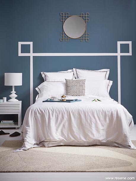 A hotel inspired bedroom in dark blue and white