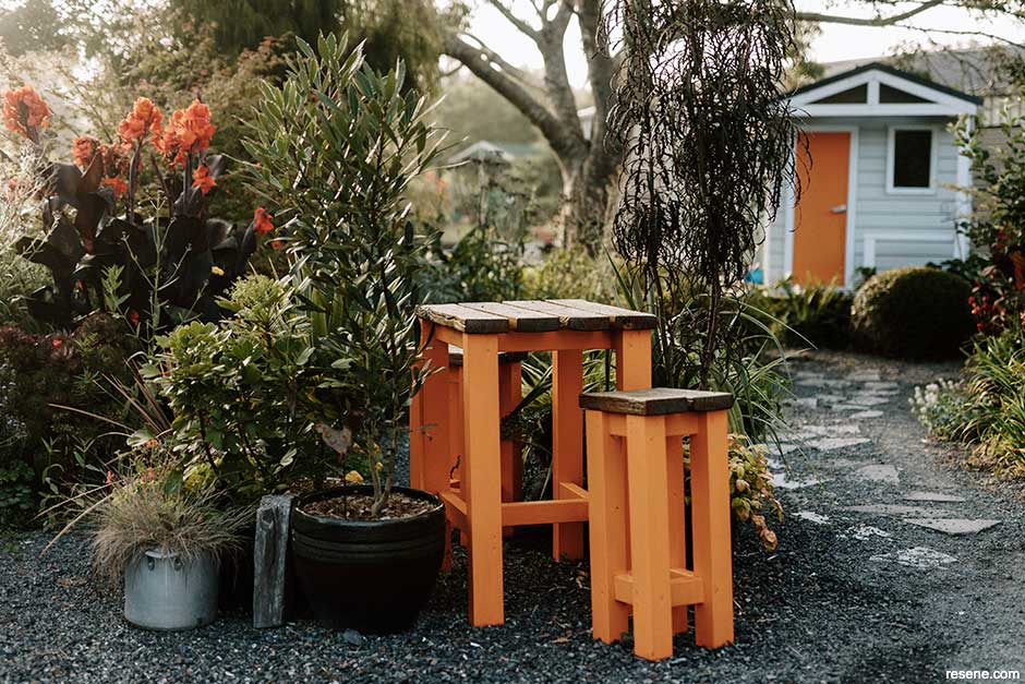 An upcycled stool set paint in vivid orange - Resene Adrenalin