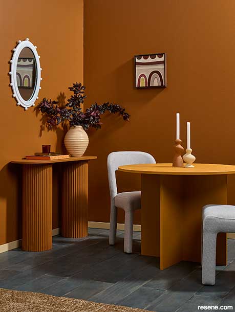 A cosy terracotta dining room in Resene Cinnamon