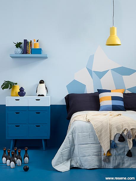 A child's bedroom with a painted iceberg mural