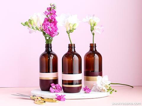 Upcycle glass bottles into trendy vases for your kitchen or table 