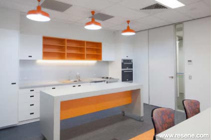 Orange and white office kitchen