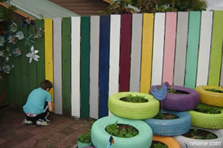Use leftover paint to create a colourful fence or recycled tyres for a garden feature
