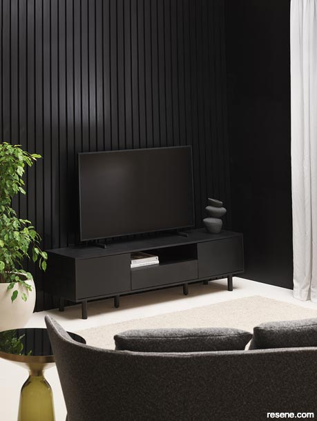A lounge with walls in Resene Blackest Black