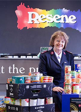 Major Lesley Nicholson with some donated cans