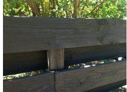 A wooden fence is transformed with Resene Woodsman Wood Oil Stain