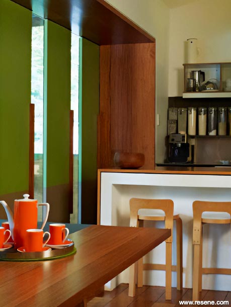 A green kitchen with timber walls