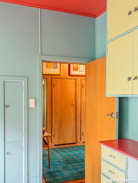 A blue, red, and yellow kitchen