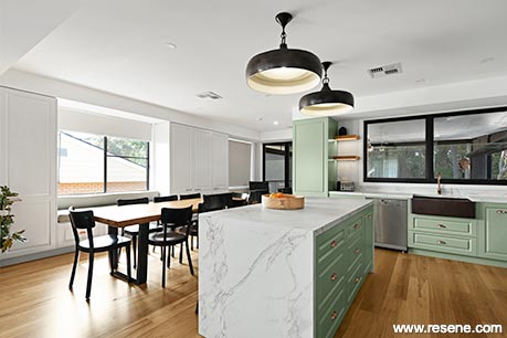 A modern green and white kitchen