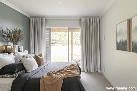 A light green and white master bedroom