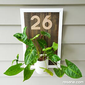 Make a rustic house number with potted plant