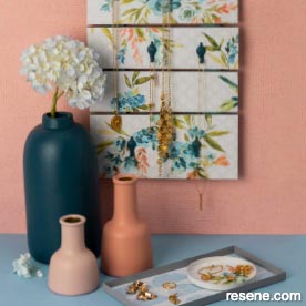 Wallpapered wall hanging, painted vases and trinket trays
