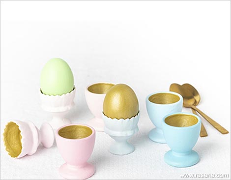 Golden eggs and pastel egg cups