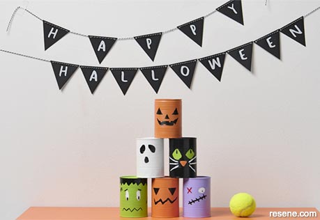 Paint halloween style tin cans for tennis ball bowling